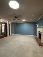 604 S Seattle Ave, Russellville, AR 72801 - unfurnished living room featuring a fireplace with raised hearth and ceiling fan