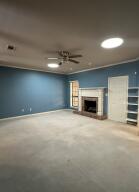 604 S Seattle Ave, Russellville, AR 72801 - unfurnished living room with a ceiling fan, baseboards, and a fireplace