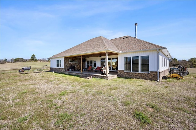 4503 Dogwood Ln, Ozark, AR 72949 - rear view of house featuring ceiling fan, a patio area, a lawn, and stone siding