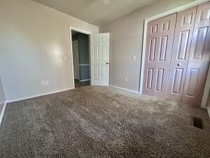 unfurnished bedroom featuring carpet and a closet