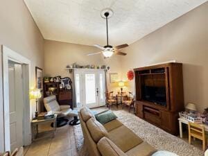 living area with tile patterned floors and a ceiling fan