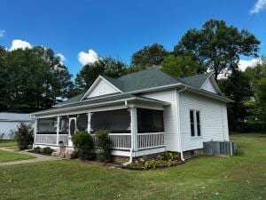 exterior space with a yard and a sunroom
