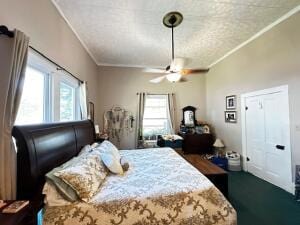 bedroom with ornamental molding and a ceiling fan