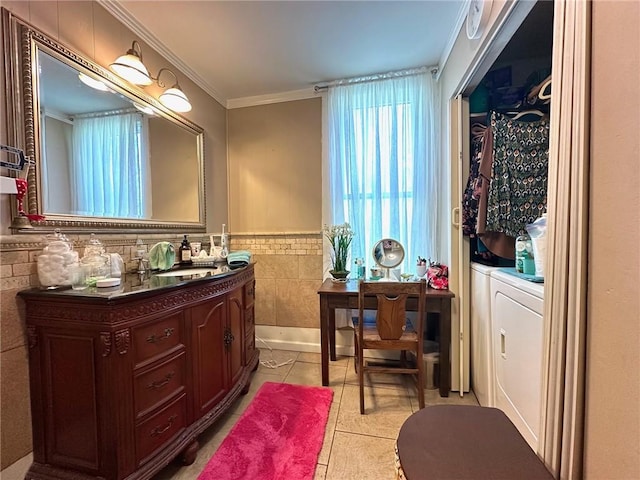 bathroom with vanity, ornamental molding, wainscoting, tile walls, and tile patterned floors
