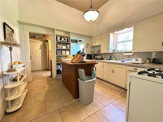 kitchen with white cabinetry, light countertops, white range with gas cooktop, and open shelves