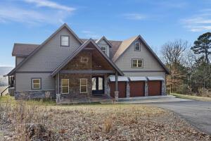 1053 Tucker Mountain Rd, Dover, AR 72837 - view of front facade with an attached garage and driveway