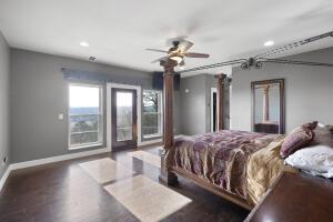 1053 Tucker Mountain Rd, Dover, AR 72837 - bedroom featuring decorative columns, recessed lighting, access to exterior, wood finished floors, and baseboards