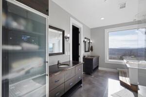 1053 Tucker Mountain Rd, Dover, AR 72837 - full bathroom featuring two vanities, finished concrete flooring, baseboards, and a sink