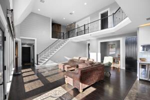1053 Tucker Mountain Rd, Dover, AR 72837 - living room with stairway, wood finished floors, and a towering ceiling