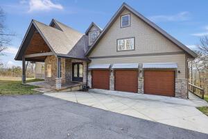 1053 Tucker Mountain Rd, Dover, AR 72837 - view of front of property featuring a garage, driveway, and stone siding