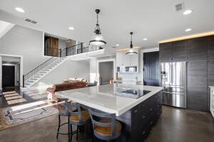 1053 Tucker Mountain Rd, Dover, AR 72837 - kitchen featuring concrete floors, stainless steel refrigerator with ice dispenser, a center island, light countertops, and hanging light fixtures