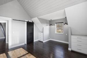 1053 Tucker Mountain Rd, Dover, AR 72837 - additional living space featuring wood finished floors, baseboards, vaulted ceiling, and a barn door