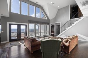 1053 Tucker Mountain Rd, Dover, AR 72837 - living area featuring french doors, stairway, plenty of natural light, and wood finished floors