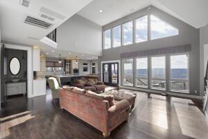 1053 Tucker Mountain Rd, Dover, AR 72837 - living room with a high ceiling, dark wood-style flooring, and visible vents