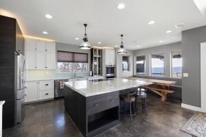 1053 Tucker Mountain Rd, Dover, AR 72837 - kitchen featuring a kitchen breakfast bar, white cabinets, recessed lighting, a large island, and light countertops