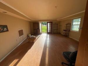 11307 Lakeridge Rd, Dardanelle, AR 72834 - unfurnished living room featuring baseboards, dark wood-style floors, and plenty of natural light