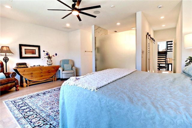 203 S W Ave Unit 1, Fayetteville, AR 72701 - bedroom featuring wood finished floors, recessed lighting, and a ceiling fan