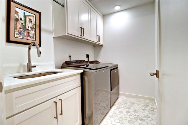 203 S W Ave Unit 1, Fayetteville, AR 72701 - washroom featuring washer and clothes dryer, cabinet space, and baseboards