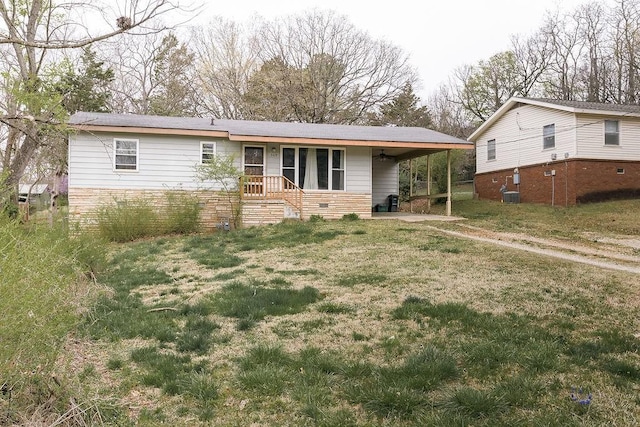 view of front of property with a front lawn, cooling unit, and a carport