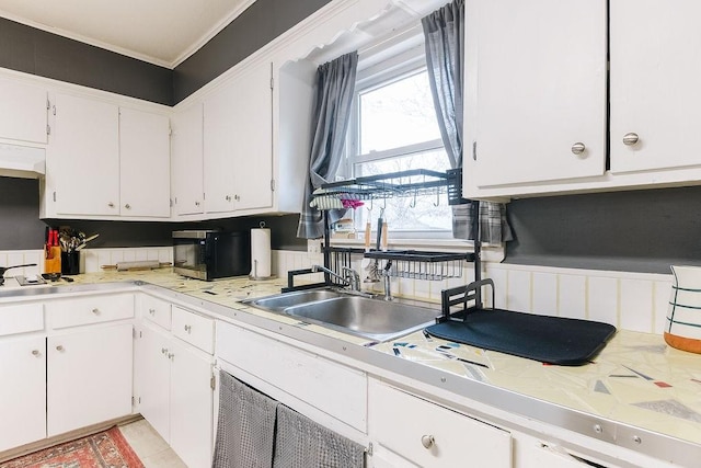kitchen featuring light countertops, white cabinets, and extractor fan