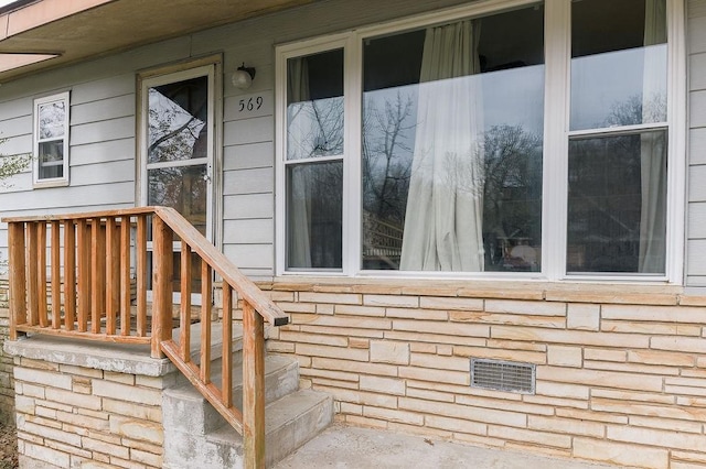 entrance to property with stone siding