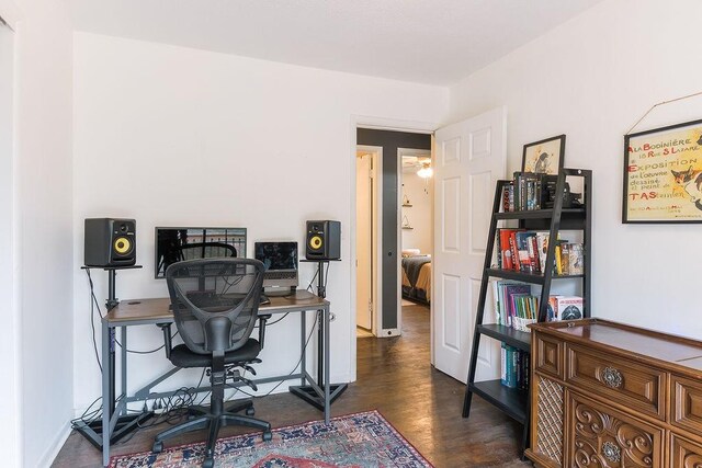 office space featuring baseboards and wood finished floors