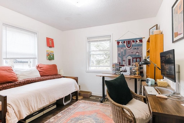 bedroom with baseboards and a textured ceiling