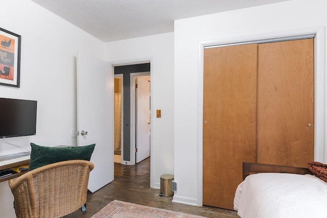bedroom with baseboards, a closet, and a textured ceiling