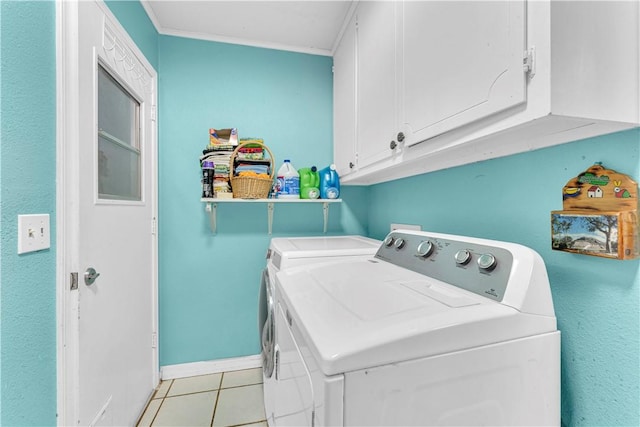 washroom with washer and clothes dryer, cabinet space, baseboards, and light tile patterned floors