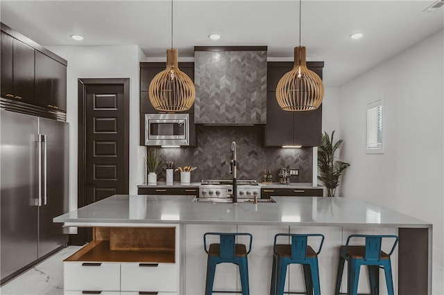 1151 NE Monroe St, Bentonville, AR 72712 - kitchen with stainless steel appliances, a breakfast bar, modern cabinets, backsplash, and recessed lighting
