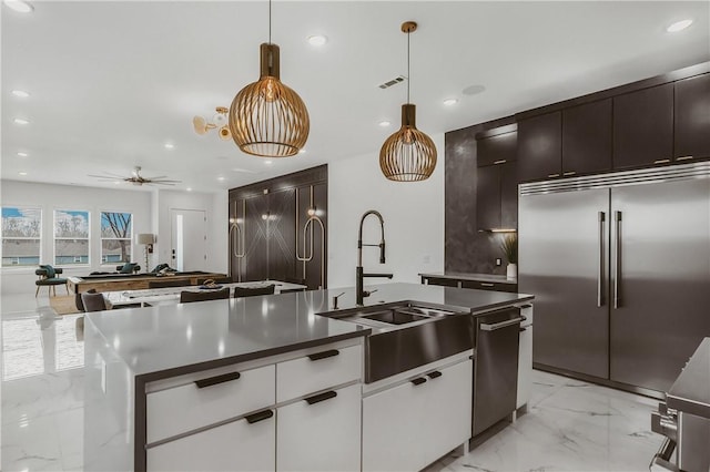 1151 NE Monroe St, Bentonville, AR 72712 - kitchen featuring stainless steel appliances, a sink, light marble finish floors, recessed lighting, and dark countertops