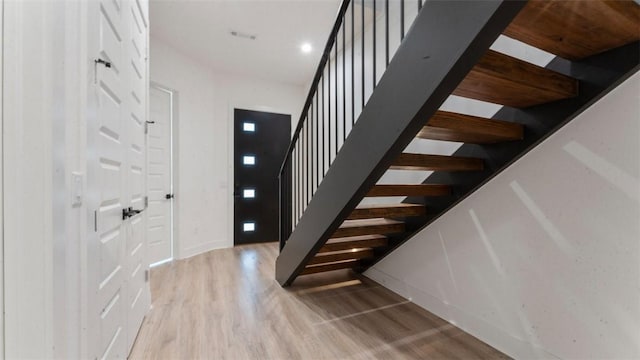 225 SE 7th St, Bentonville, AR 72712 - staircase with wood finished floors and baseboards