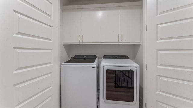 225 SE 7th St, Bentonville, AR 72712 - laundry room featuring separate washer and dryer and cabinet space