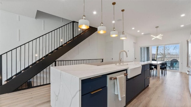 225 SE 7th St, Bentonville, AR 72712 - kitchen featuring a sink, stainless steel dishwasher, light wood-style floors, recessed lighting, and open floor plan