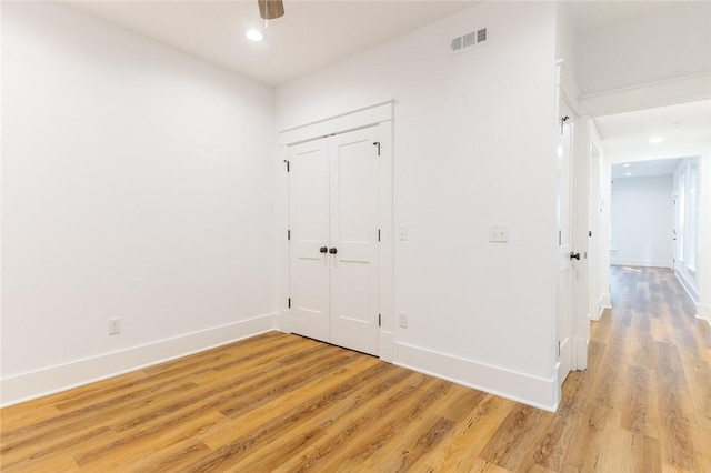 144 N Washington Ave Unit 102, Fayetteville, AR 72701 - unfurnished bedroom with baseboards, light wood-type flooring, and visible vents