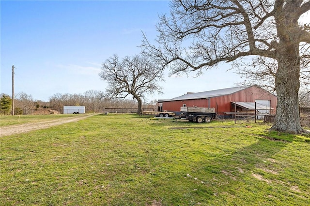 view of yard with an outbuilding, fence, an outdoor structure, and a garage