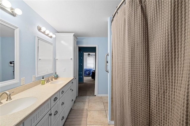 bathroom featuring tile patterned floors, double vanity, and a sink