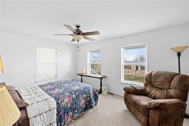 carpeted bedroom with baseboards and a ceiling fan