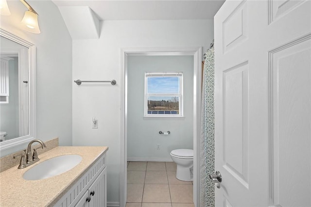 bathroom featuring tile patterned floors, toilet, baseboards, and vanity