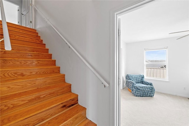 stairs with baseboards and carpet flooring