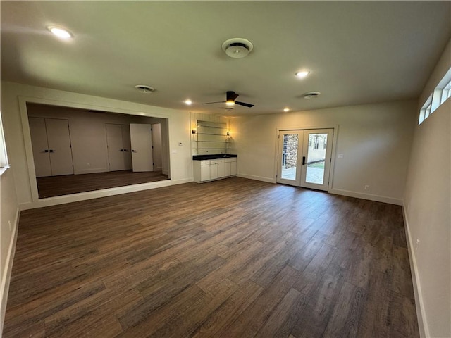 unfurnished living room featuring french doors, a ceiling fan, baseboards, recessed lighting, and dark wood-style flooring