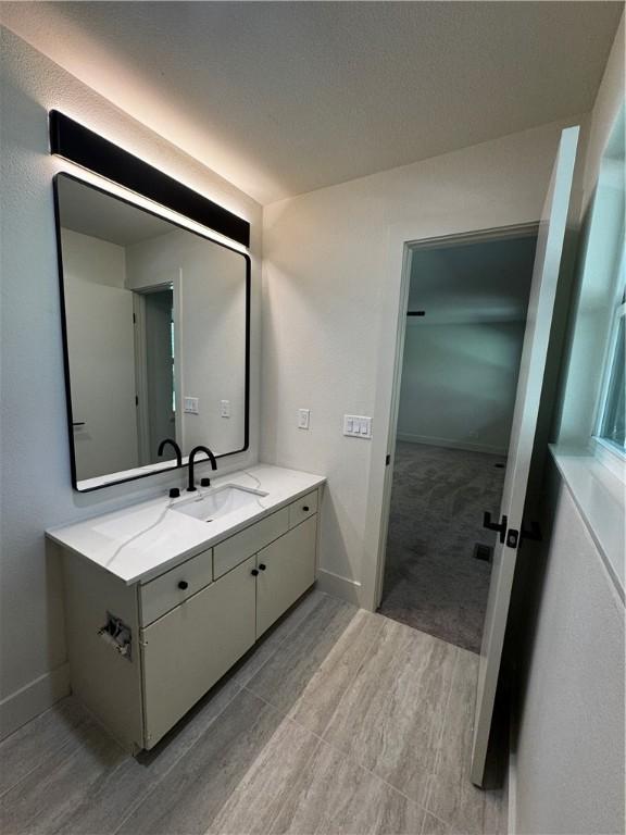 bathroom with baseboards and vanity