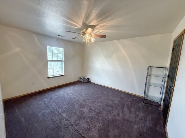 5 Arrowhead Ln, Clarksville, AR 72830 - empty room featuring dark colored carpet, a ceiling fan, and baseboards
