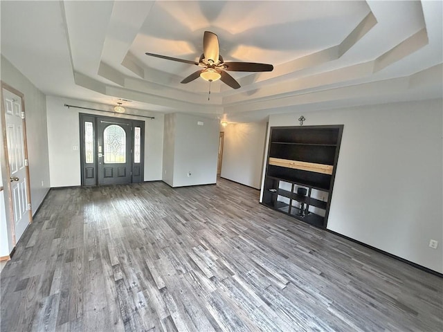 5 Arrowhead Ln, Clarksville, AR 72830 - unfurnished living room featuring a tray ceiling, wood finished floors, and a ceiling fan