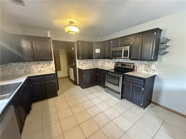 5 Arrowhead Ln, Clarksville, AR 72830 - kitchen with stainless steel appliances, backsplash, a sink, and light countertops