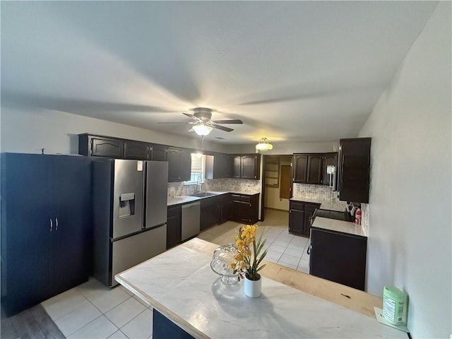 5 Arrowhead Ln, Clarksville, AR 72830 - kitchen featuring stainless steel appliances, backsplash, a ceiling fan, and light tile patterned floors