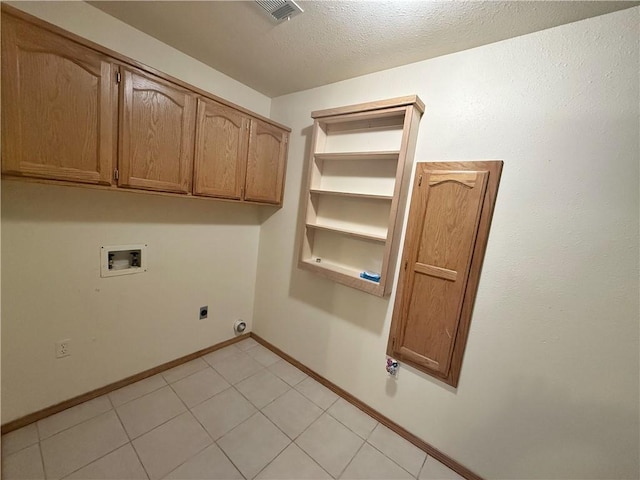 5 Arrowhead Ln, Clarksville, AR 72830 - clothes washing area with washer hookup, electric dryer hookup, cabinet space, baseboards, and a textured ceiling