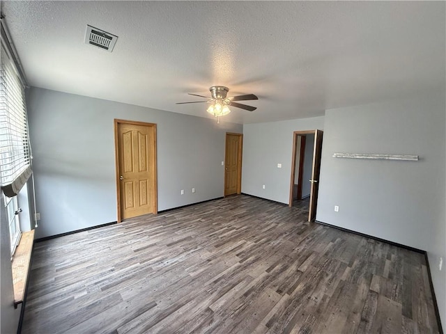 5 Arrowhead Ln, Clarksville, AR 72830 - spare room featuring wood finished floors, a ceiling fan, a textured ceiling, and baseboards