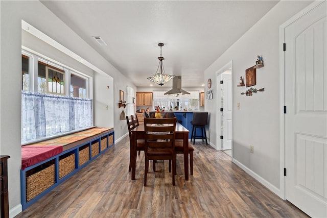 dining room with dark wood-style flooring, baseboards, and visible vents