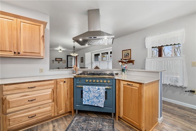 kitchen featuring dark wood-style floors, island range hood, range with two ovens, and light countertops